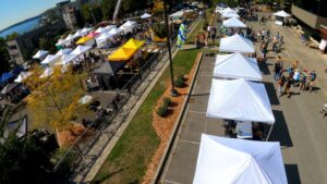 An overhead photo showing many 10x10 canopies in a parking lot at an event